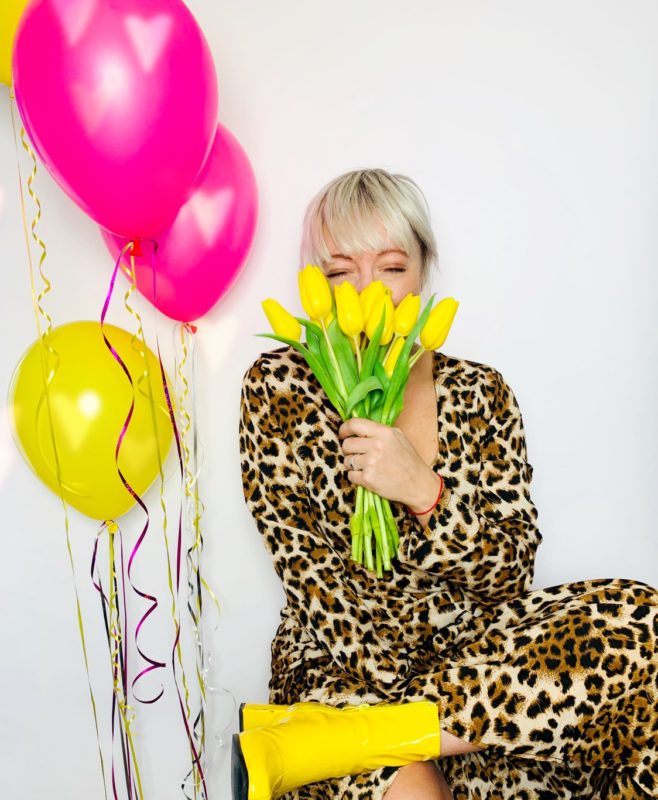 Casie Stewart, pink and yellow balloons, spring flowers, leopard dress, having fun.